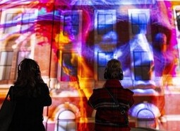 The unveiling of a specially commissioned AI artwork from Ouchhh Studio, made using cognitive technology to visualise brainwaves of the Arts & Film ‘Game Changers’ and projected across the façade of the V&A’s Exhibition Road Courtyard building in London, as part of The National Lottery’s 30th birthday celebrations.