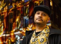 Adam Joolia attends the unveiling of a specially commissioned AI artwork from Ouchhh Studio, made using cognitive technology to visualise brainwaves of the Arts & Film ‘Game Changers’ and projected across the façade of the V&A’s Exhibition Road Courtyard building in London, as part of The National Lottery’s 30th birthday celebrations. 